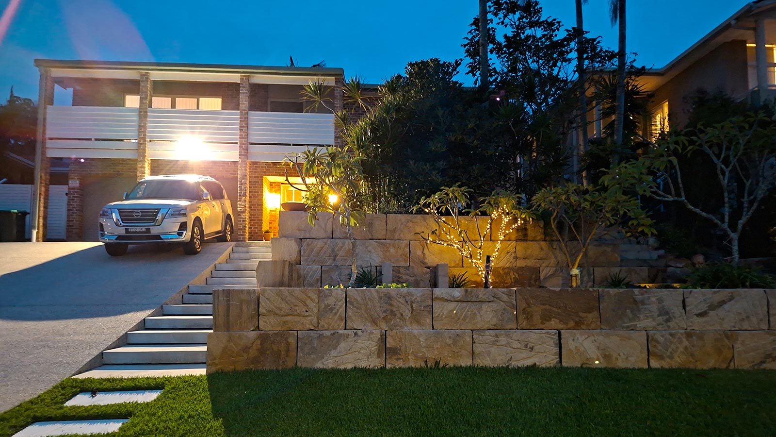 Fingal Bay front garden after the sandstone terraces, stairs and garden lighting were installed