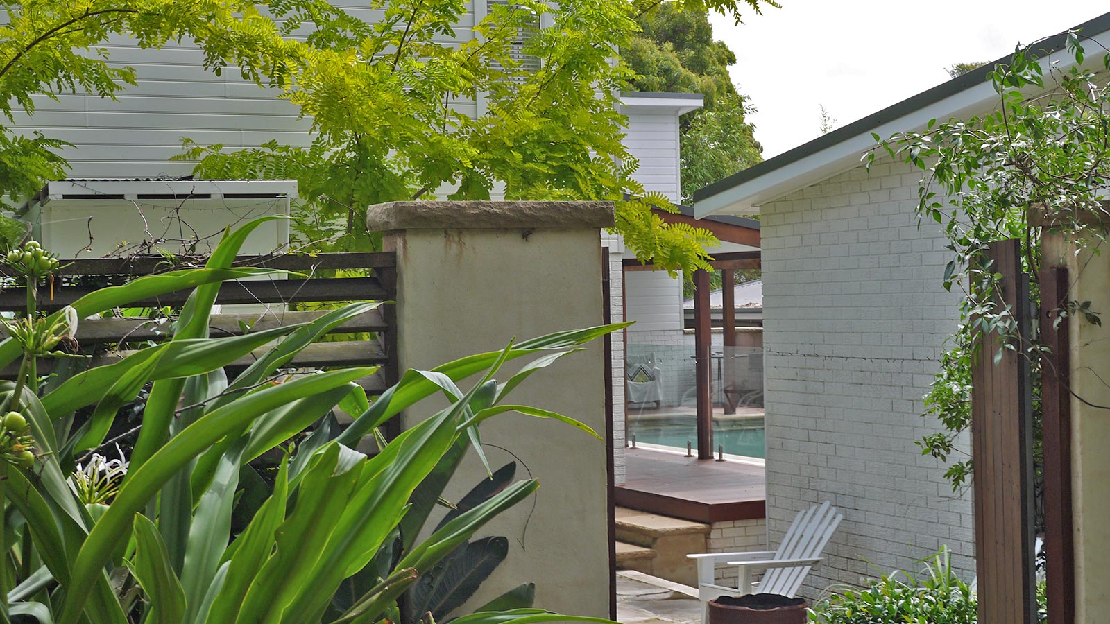 Hilltop garden after the pool, deck, sandstone walls and layered planting were completed