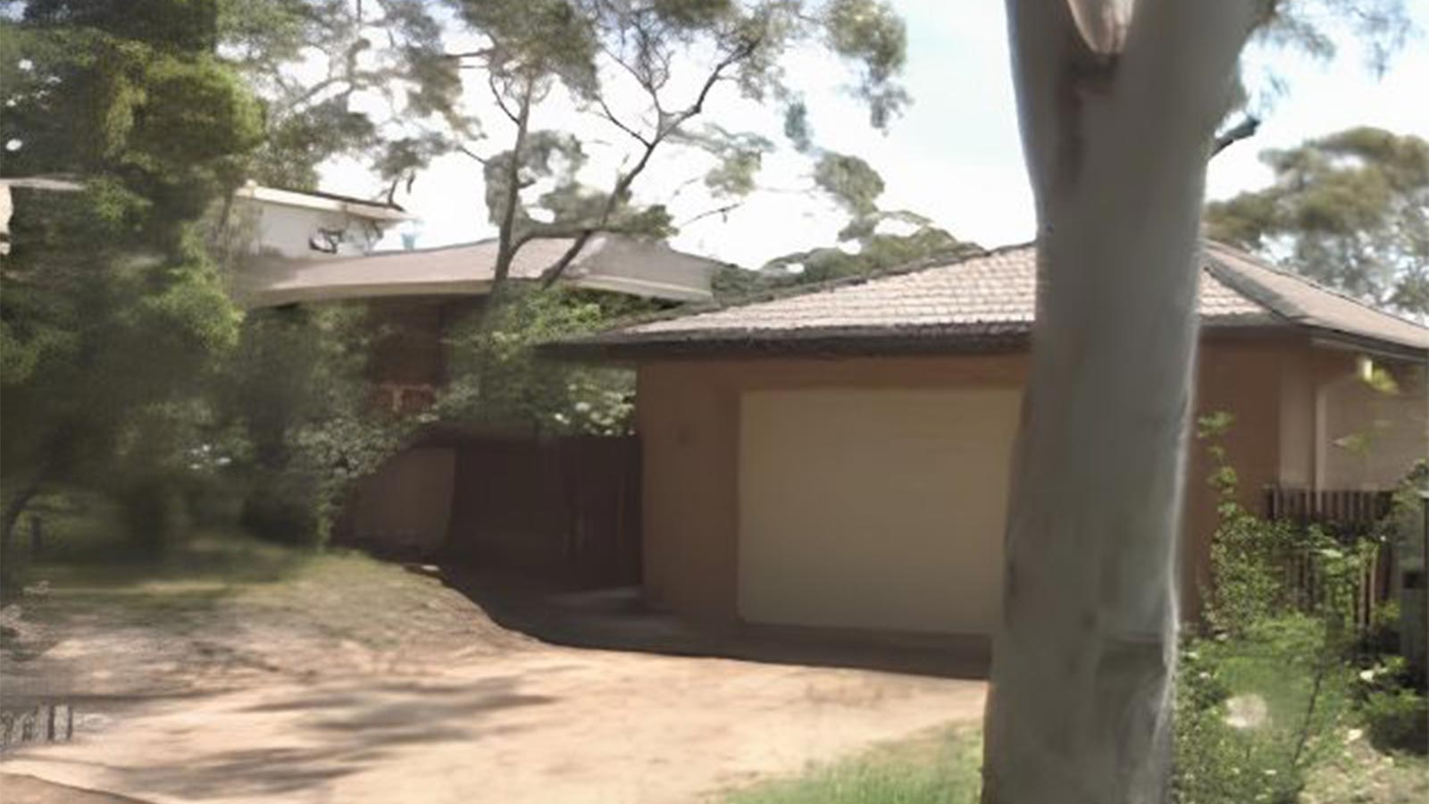 Hilltop property before the driveway was transformed into a pool and outdoor living area